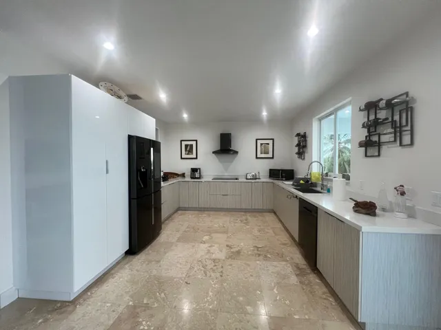 a living room with furniture a window and a flat screen tv