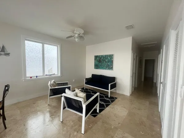 a view of a livingroom with furniture and window in it