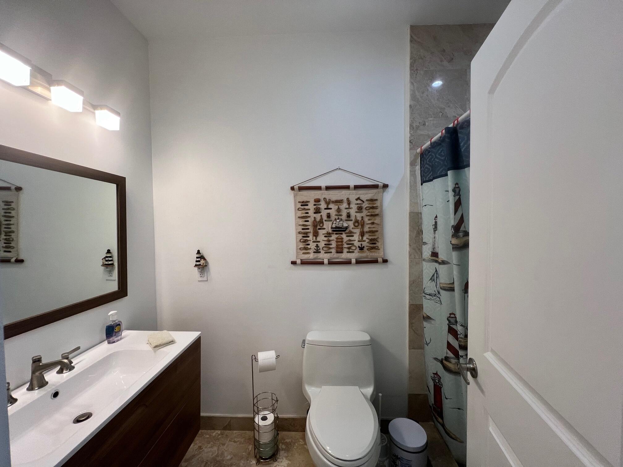 4 Pelican Road Key Largo, FL 33037 - Photo 9 of 15 a bathroom with a toilet sink and mirror