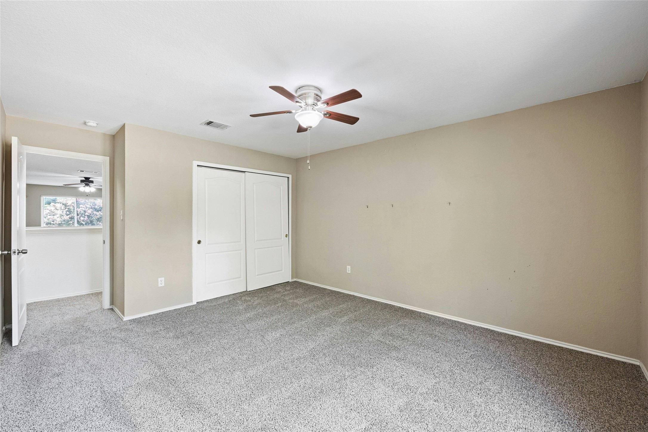 3618 Windhill Loop Round Rock, TX 78681 - Photo 16 of 30 Upstairs bedroom with closet, carpet floors, and a ceiling fan