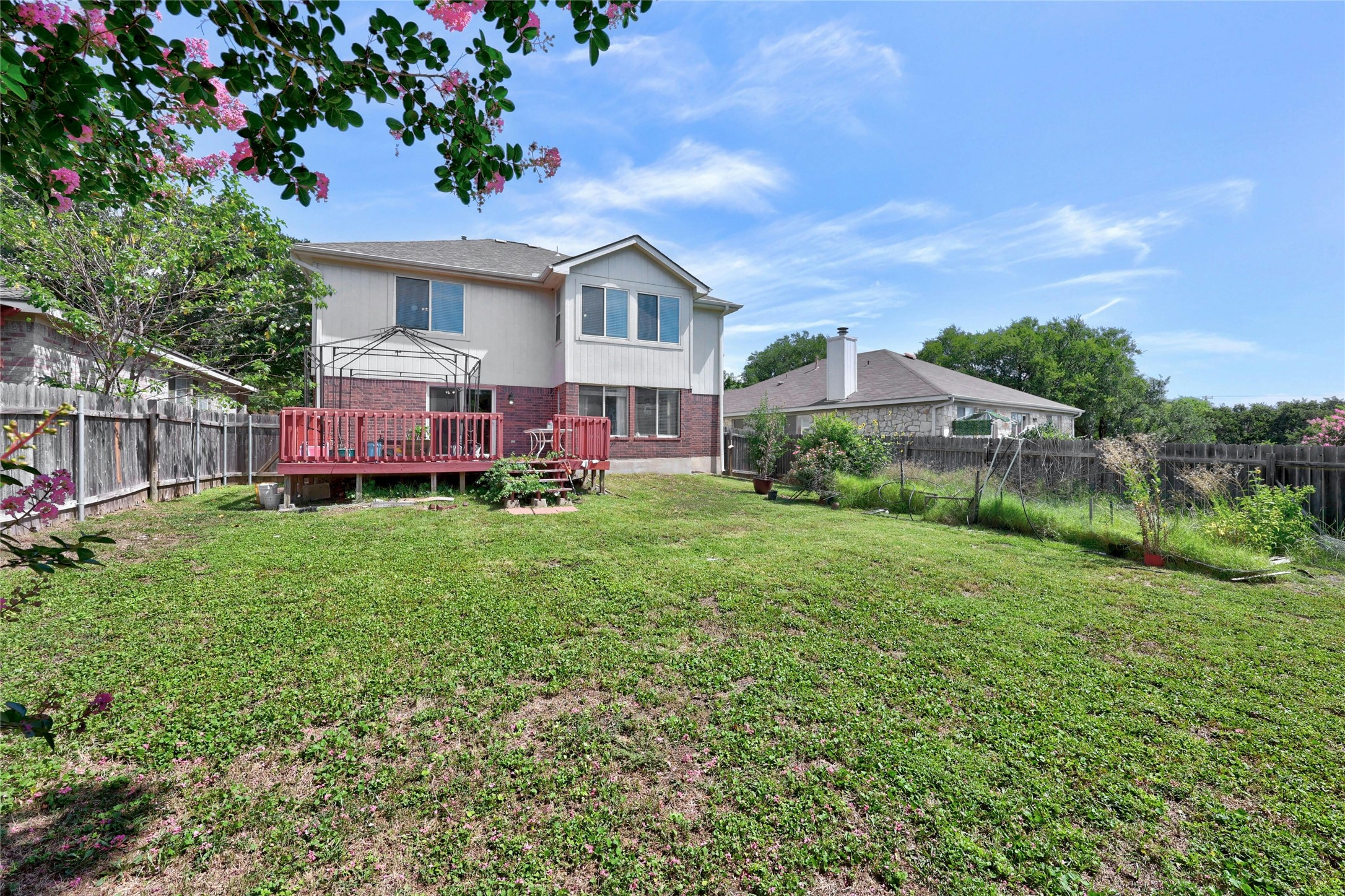 3618 Windhill Loop Round Rock, TX 78681 - Photo 27 of 30 Rear view of house with a fenced backyard, a deck. Garden area has been cleared.