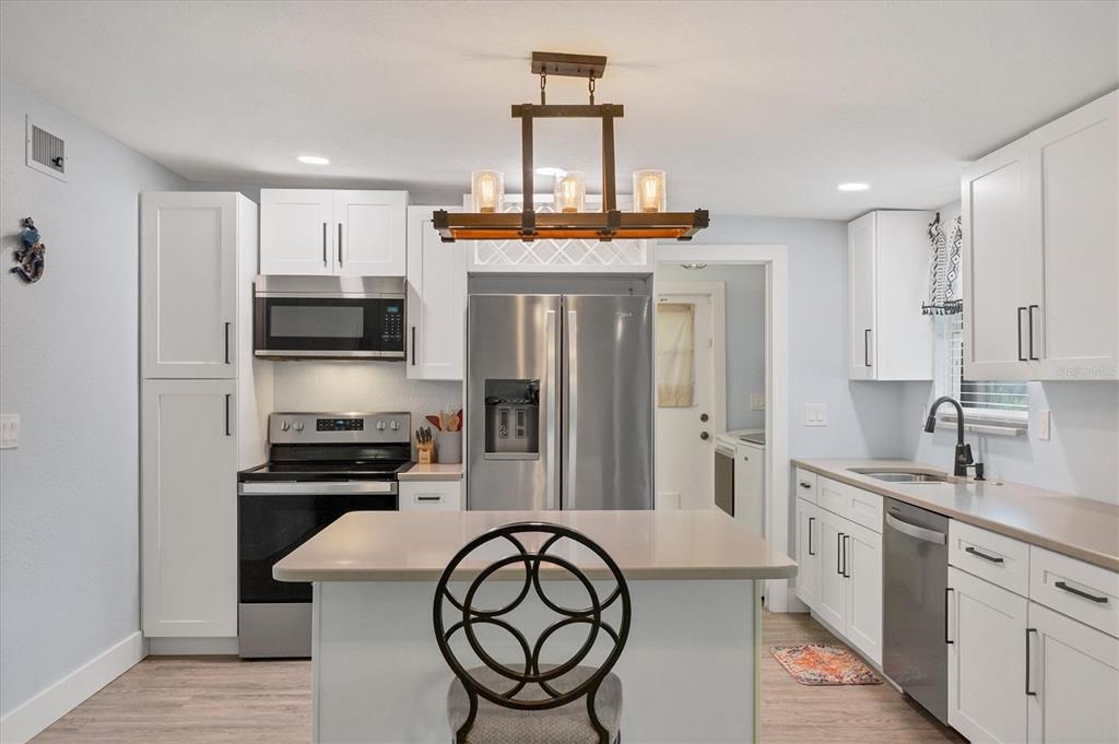 2254 Hayworth Road Port Charlotte, FL 33952 - Photo 16 of 48 a kitchen with stainless steel appliances a stove a sink and a refrigerator