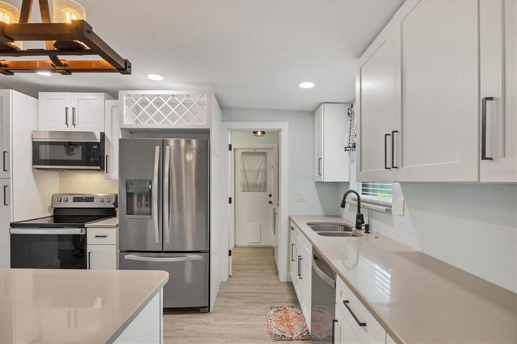 2254 Hayworth Road Port Charlotte, FL 33952 - Photo 18 of 48 a kitchen with stainless steel appliances granite countertop a sink a stove and a refrigerator