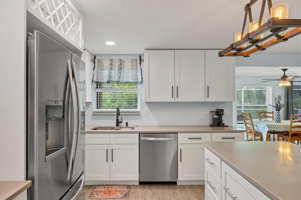 2254 Hayworth Road Port Charlotte, FL 33952 - Photo 19 of 48 a kitchen with white cabinets and white appliances