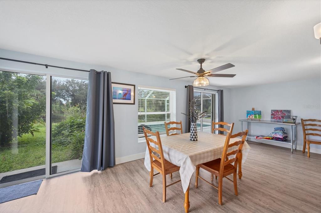 2254 Hayworth Road Port Charlotte, FL 33952 - Photo 24 of 48 a dining room with furniture window and wooden floor