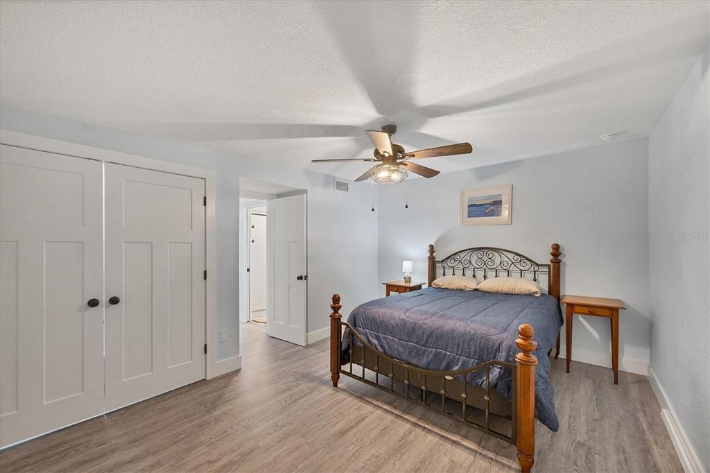 2254 Hayworth Road Port Charlotte, FL 33952 - Photo 25 of 48 a bedroom with a bed and a chandelier