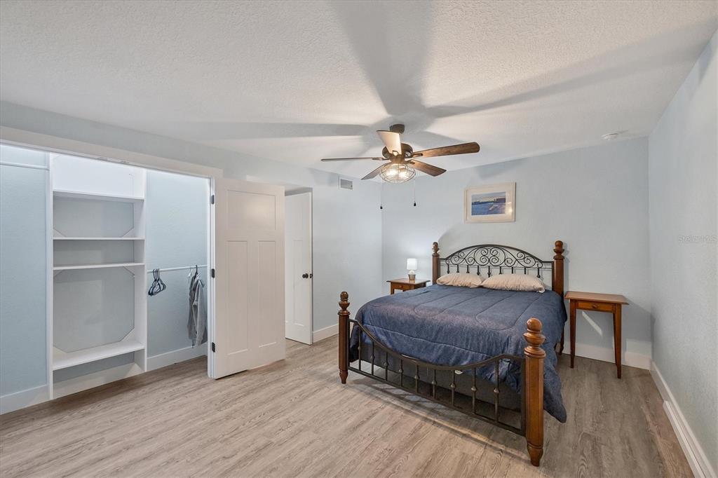 2254 Hayworth Road Port Charlotte, FL 33952 - Photo 26 of 48 a bedroom with a bed and a chandelier