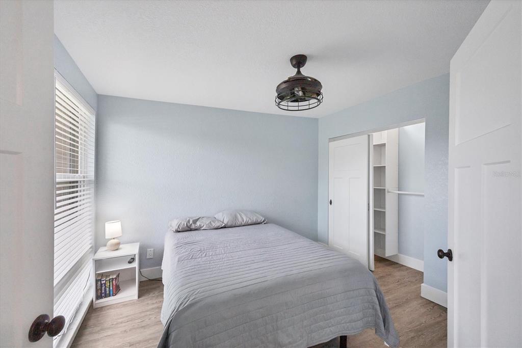 2254 Hayworth Road Port Charlotte, FL 33952 - Photo 29 of 48 a bedroom with a bed and a chandelier