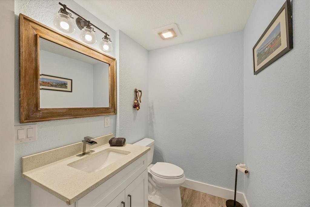 2254 Hayworth Road Port Charlotte, FL 33952 - Photo 30 of 48 a bathroom with a toilet sink and mirror