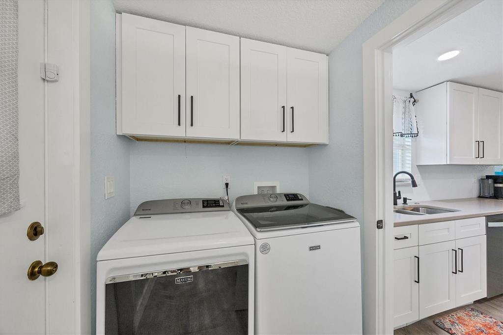 2254 Hayworth Road Port Charlotte, FL 33952 - Photo 31 of 48 a view of cabinets a sink a stove and cabinets in the kitchen