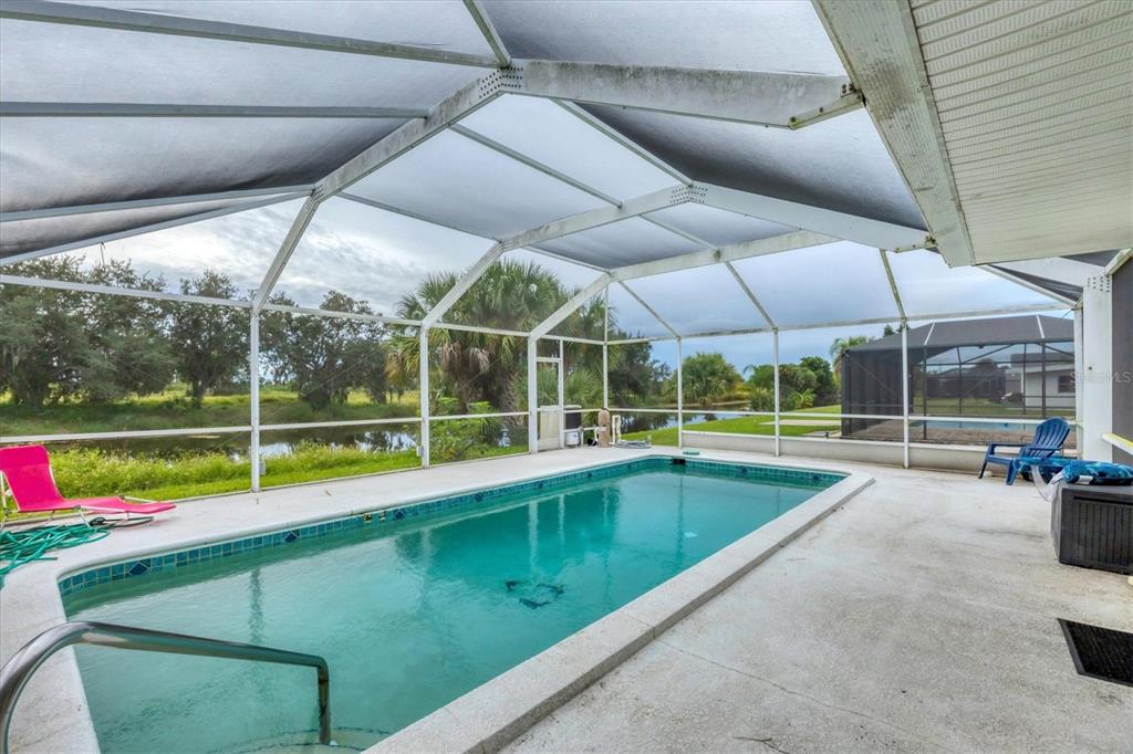 2254 Hayworth Road Port Charlotte, FL 33952 - Photo 32 of 48 a view of swimming pool with red chairs