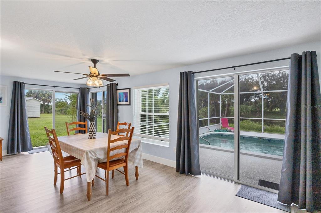 2254 Hayworth Road Port Charlotte, FL 33952 - Photo 6 of 48 a view of a dining room with furniture wooden floor and chandelier