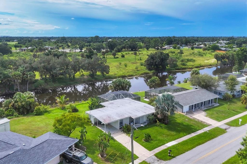 2254 Hayworth Road Port Charlotte, FL 33952 - Photo 7 of 48 a view of a lake with a yard