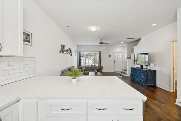 a large white kitchen with cabinets