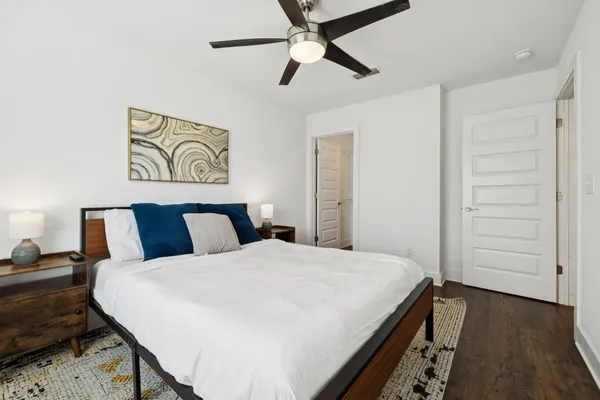 a bedroom with a bed and a chandelier