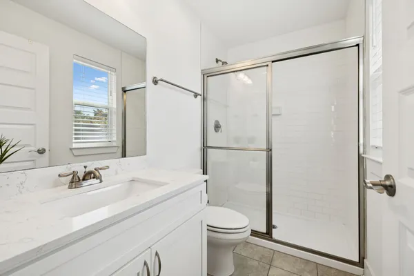 a bathroom with a sink mirror vanity and toilet