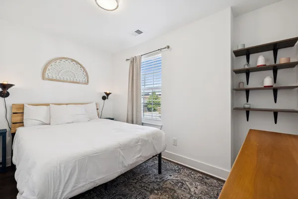 a bedroom with a bed and a window