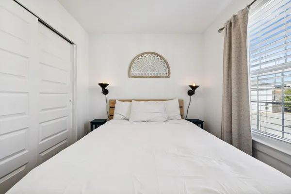 a bedroom with a bed and a window