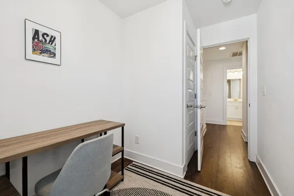 a view of hallway with wooden floor