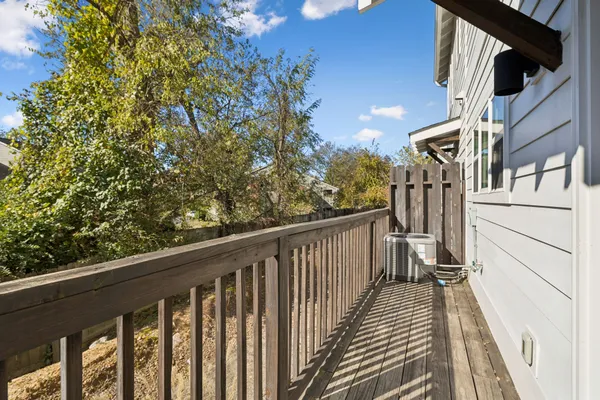 a view of balcony with wooden floor and fence