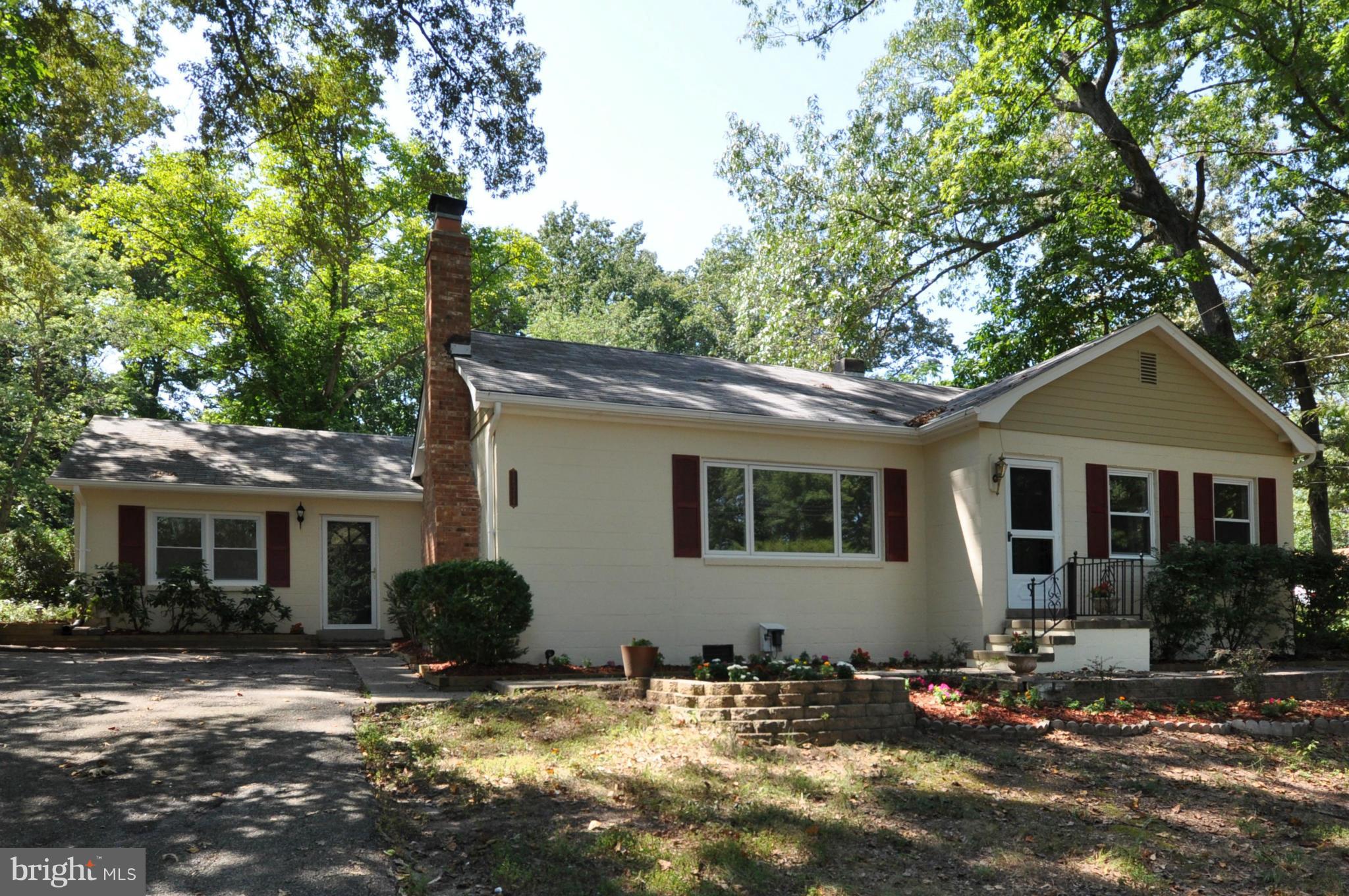 18314 Sharon Road Triangle, VA 22172 - Photo 1 of 30 a backyard of a house with yard and outdoor seating
