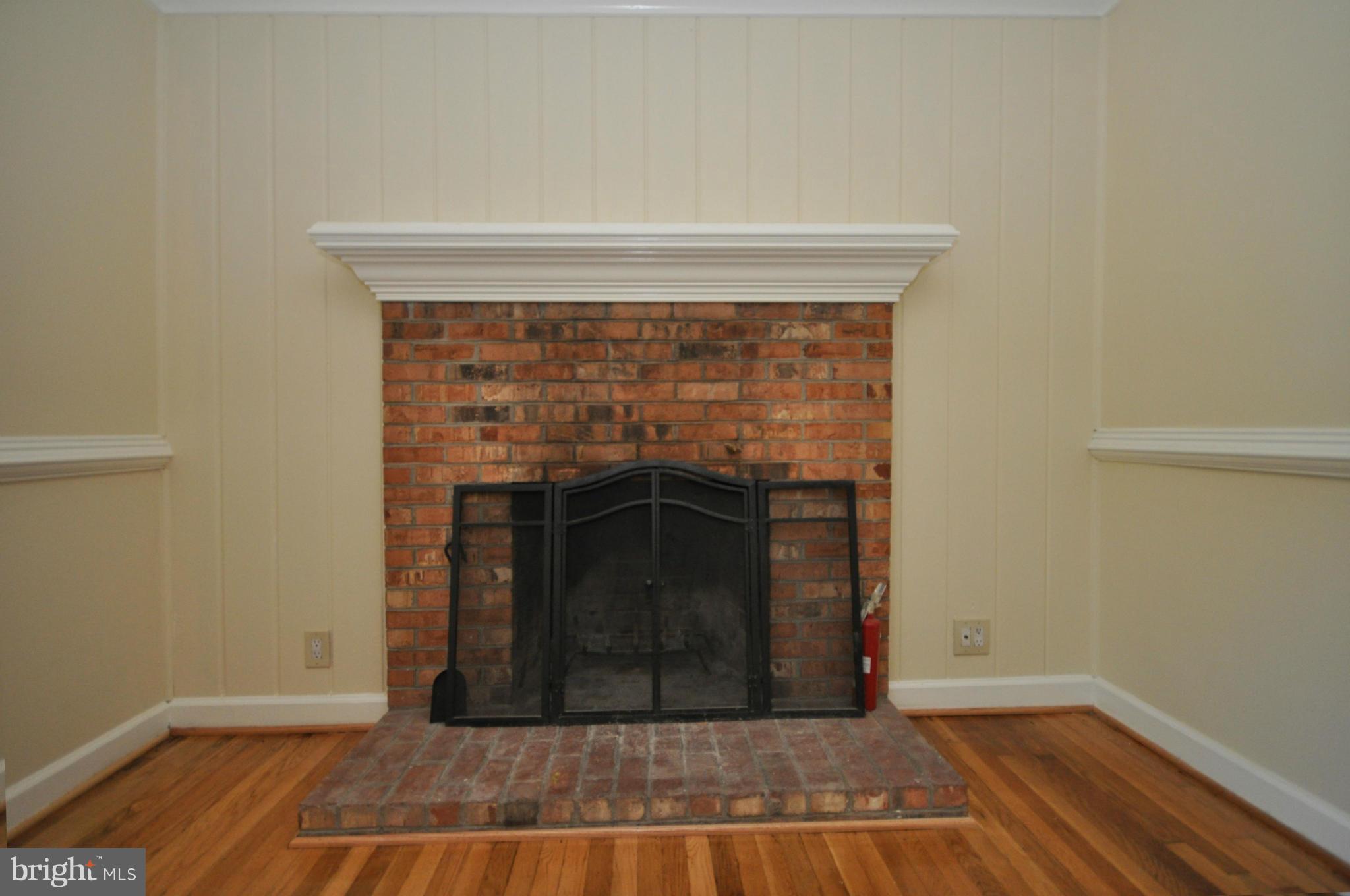 18314 Sharon Road Triangle, VA 22172 - Photo 11 of 30 a view of a livingroom with wooden floor and a fireplace