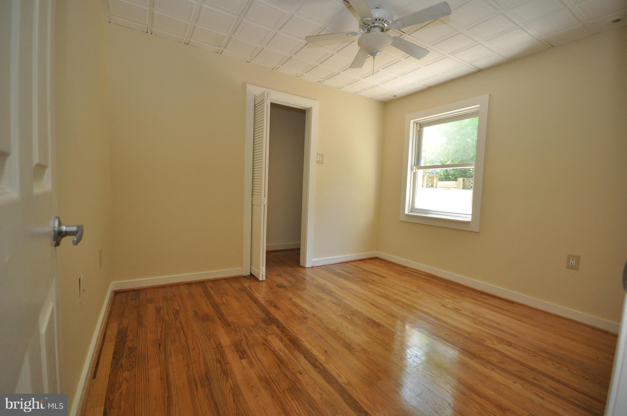 18314 Sharon Road Triangle, VA 22172 - Photo 18 of 30 a view of an empty room with wooden floor and a window