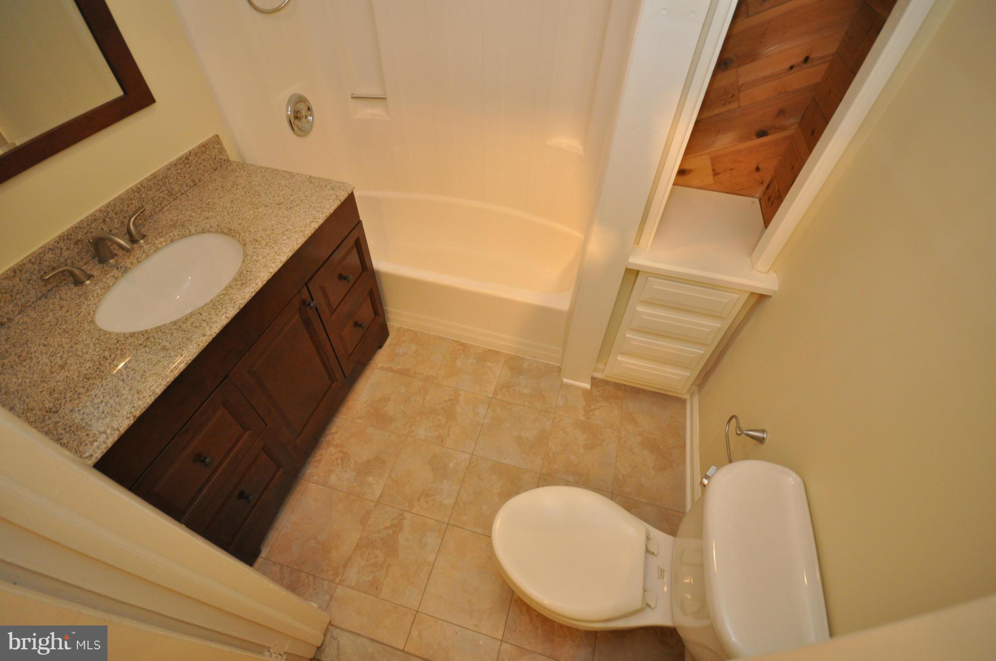 18314 Sharon Road Triangle, VA 22172 - Photo 19 of 30 a bathroom with a granite countertop sink and a mirror