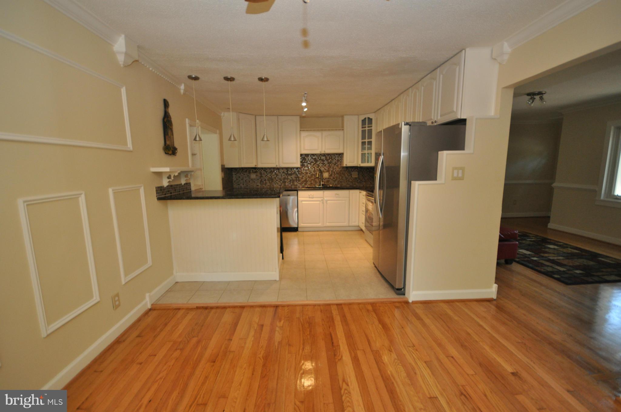 18314 Sharon Road Triangle, VA 22172 - Photo 6 of 30 a view of a kitchen with wooden floor and electronic appliances