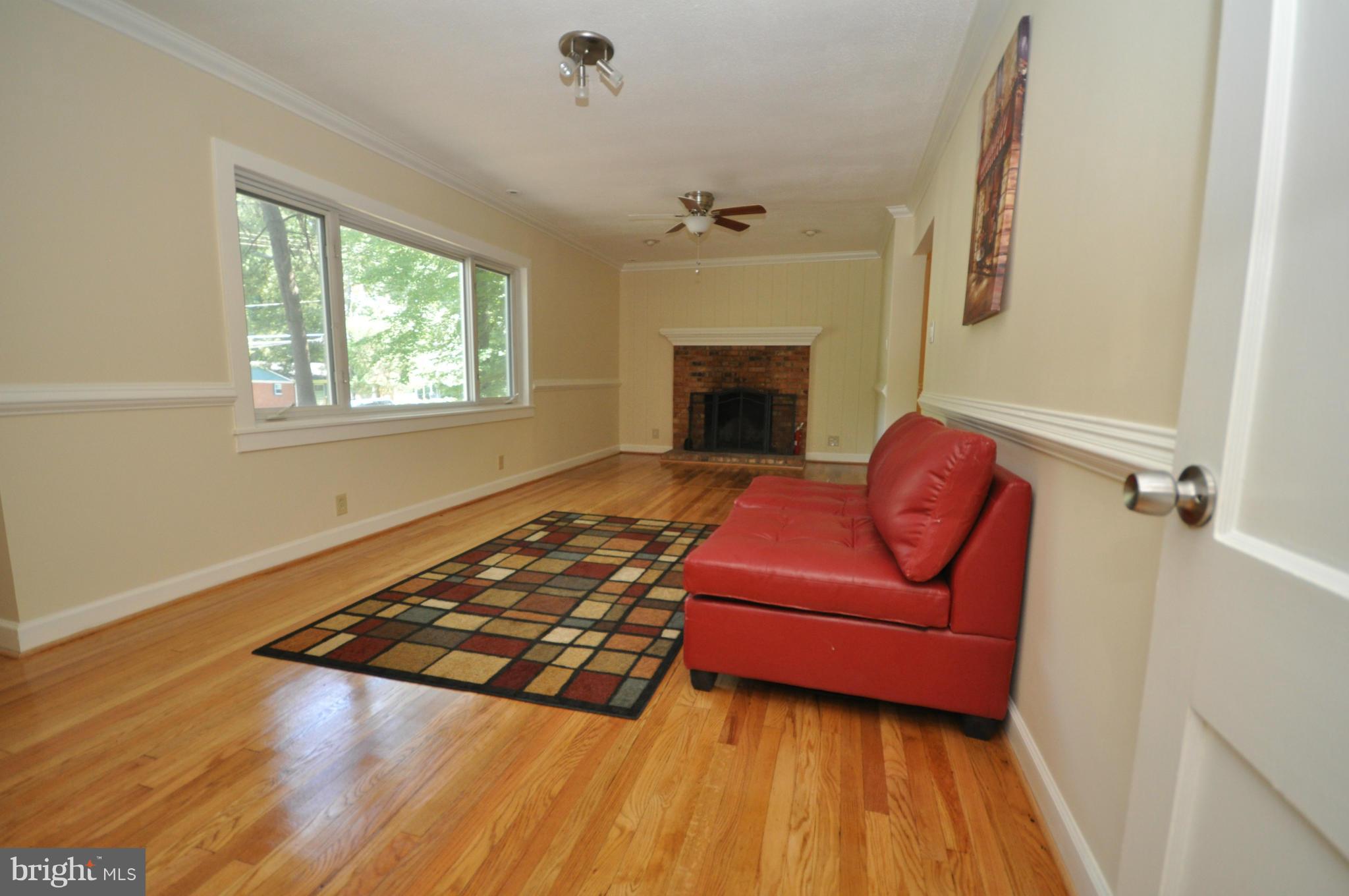 18314 Sharon Road Triangle, VA 22172 - Photo 10 of 30 a living room with furniture rug and a fireplace