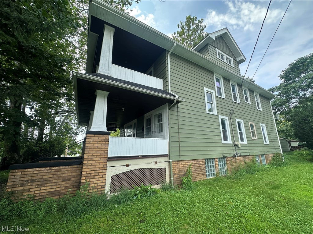 10820 Bellaire Road Cleveland, OH 44111 - Photo 2 of 24 View of side of property featuring balcony and a yard