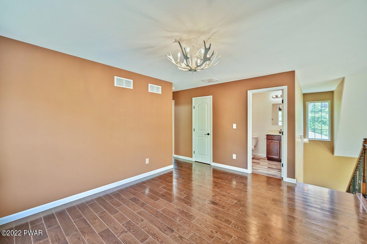 45 Rockway Road Lake Ariel, PA 18436 - Photo 45 of 65 a view of an empty room with wooden floor and a window
