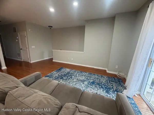 a living room with a couch and a rug