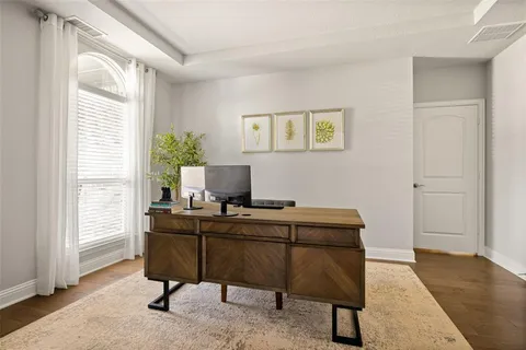 a view of a workspace with furniture and a window