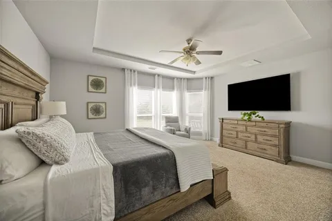a bedroom with a flat screen television and a bed
