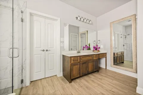 a bathroom with a sink vanity and mirror