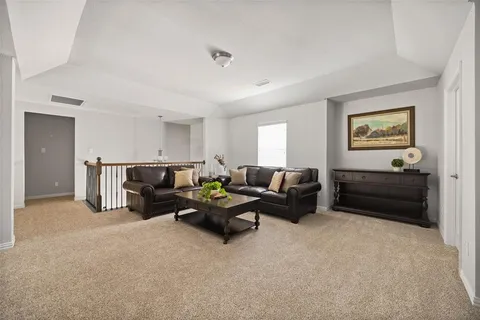 a living room with furniture and a lamp
