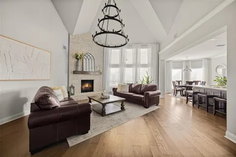 a living room with furniture a fireplace and wooden floor