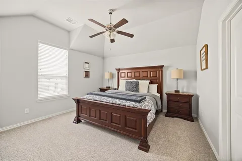 a bedroom with a bed and window