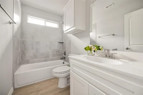 a bathroom with a sink toilet and bathtub