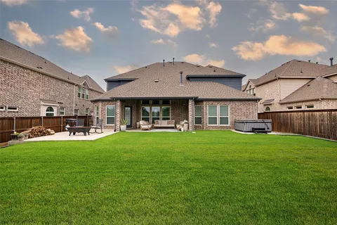 a view of a house with backyard porch and sitting area