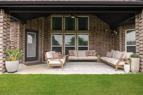 a view of a patio with a table and chairs