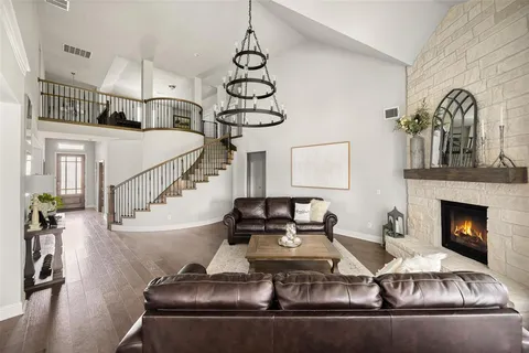 a living room with furniture fireplace and wooden floor