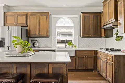 a kitchen with a sink cabinets and window