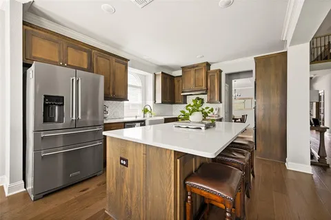 a kitchen with stainless steel appliances a sink a stove a refrigerator and cabinets