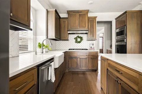 a kitchen with a sink stove and cabinets