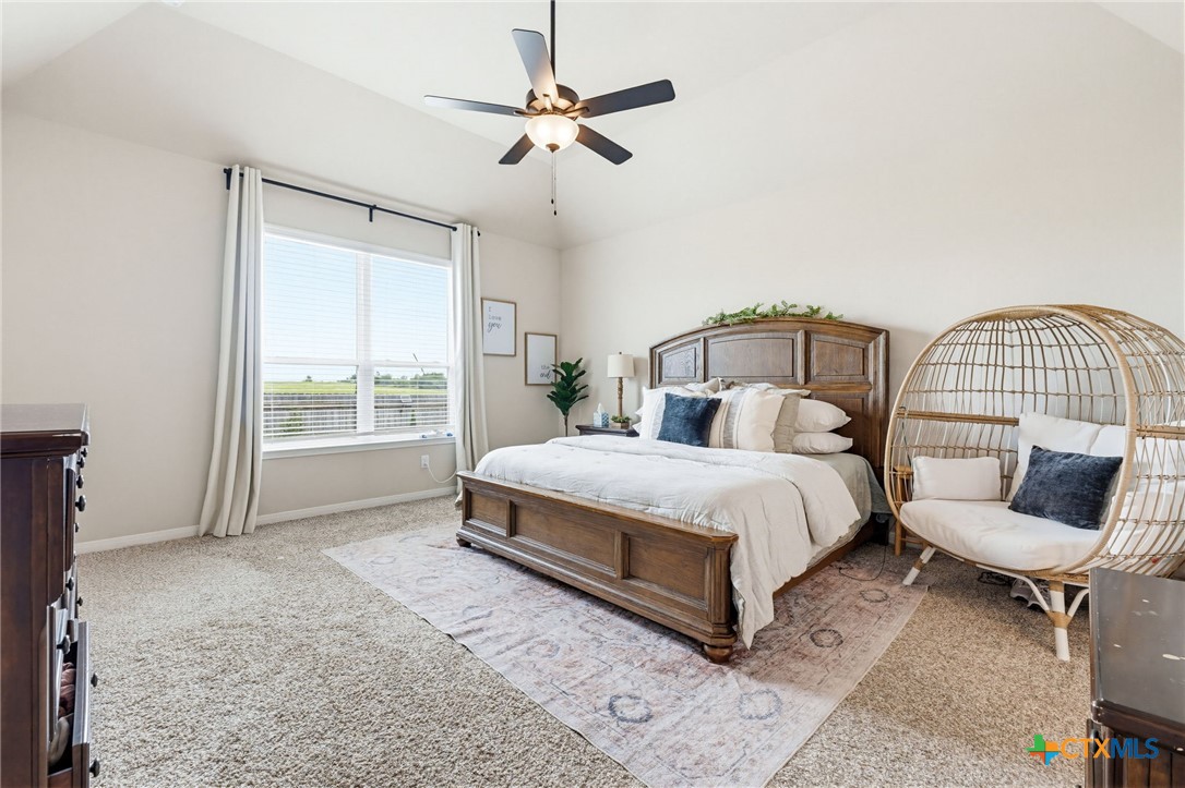 1761 Spence Street Temple, TX 76502 - Photo 14 of 30 a bedroom with a bed a couch and a chandelier