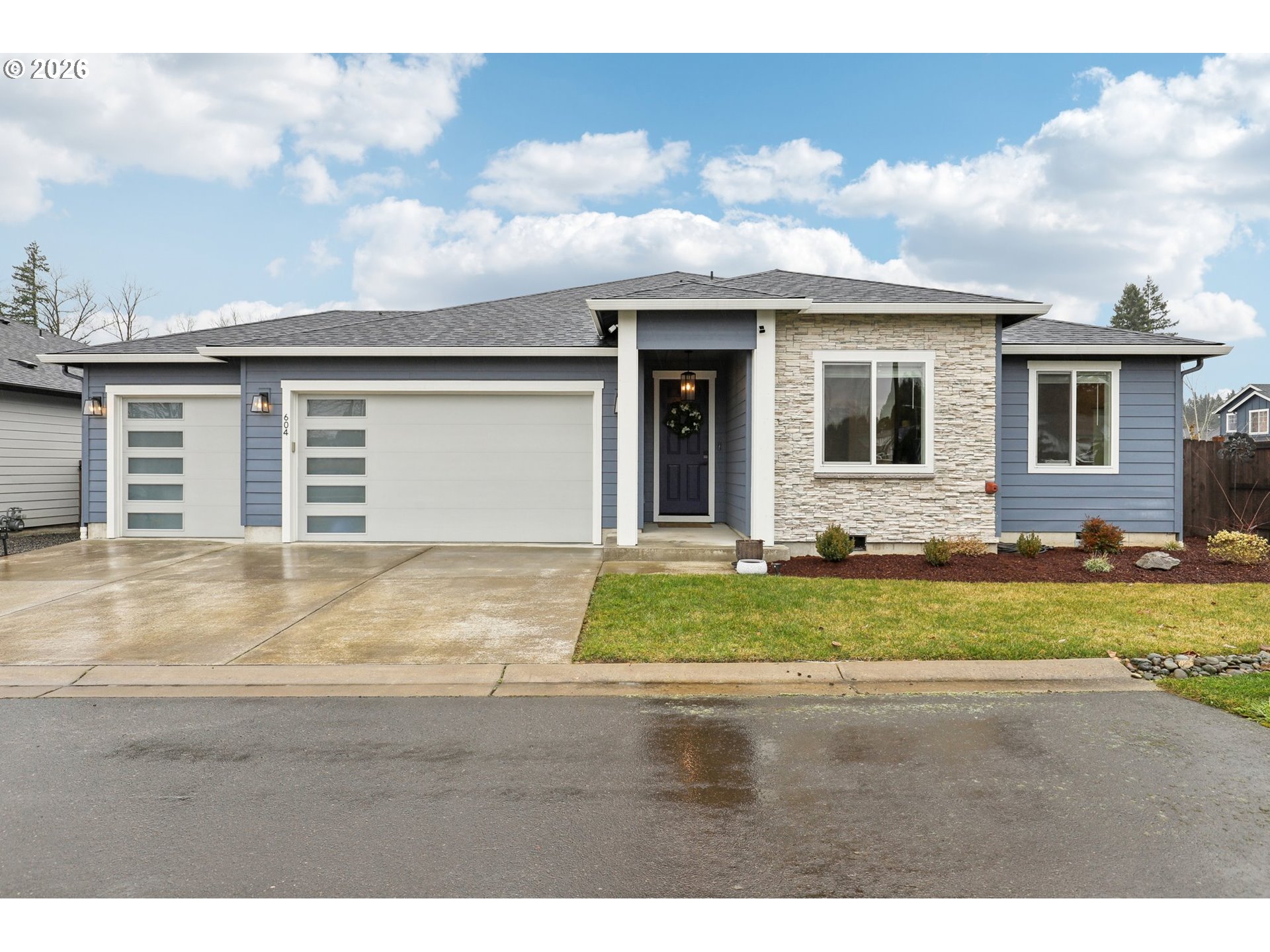 a front view of a house with a garden
