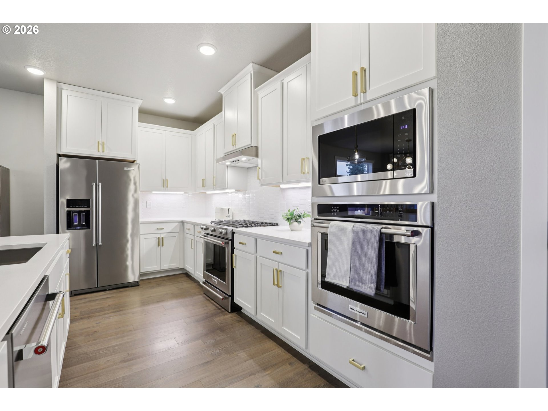 604 Northwest 25th Way Battle Ground, WA 98604 - Photo 13 of 33 a kitchen with stainless steel appliances white cabinets and a stove