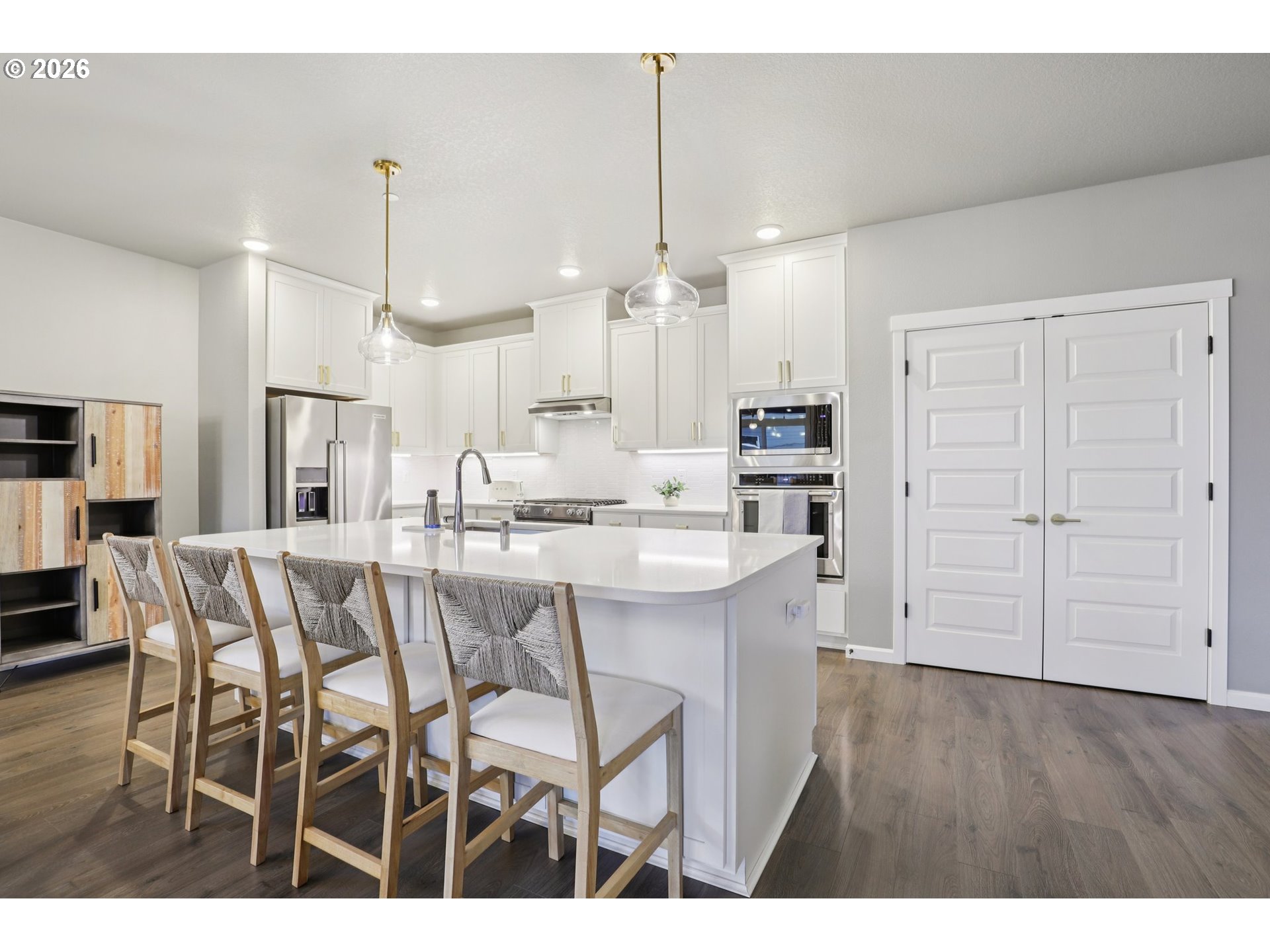 604 Northwest 25th Way Battle Ground, WA 98604 - Photo 14 of 33 a kitchen with stainless steel appliances kitchen island granite countertop a table chairs sink and cabinets